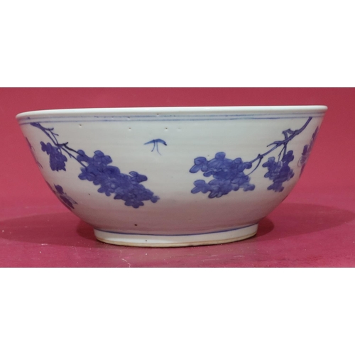 109 - An Oriental blue and white round trumpet shaped bowl with bird, branch, floral and leaf decoration, ... 