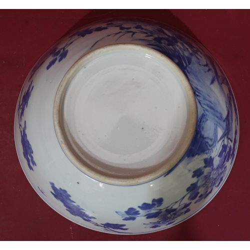 109 - An Oriental blue and white round trumpet shaped bowl with bird, branch, floral and leaf decoration, ... 