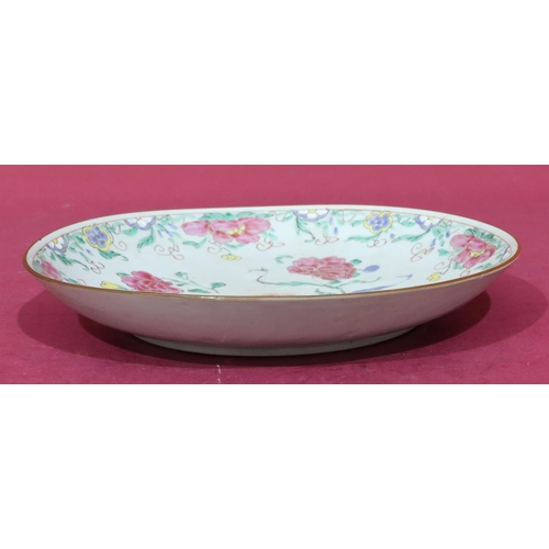 113 - An 18th Century Oriental round plate on white ground with pink, green, yellow and blue floral, leaf ... 