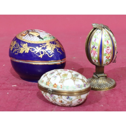 117 - A Continental porcelain egg trinket box on white ground with multicoloured floral, leaf and gilt dec... 