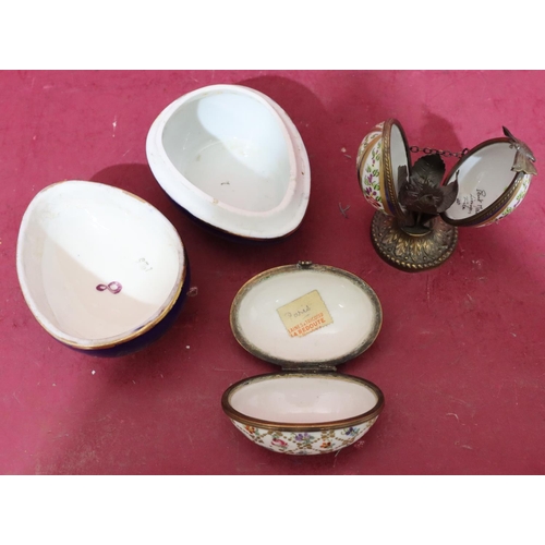 117 - A Continental porcelain egg trinket box on white ground with multicoloured floral, leaf and gilt dec... 