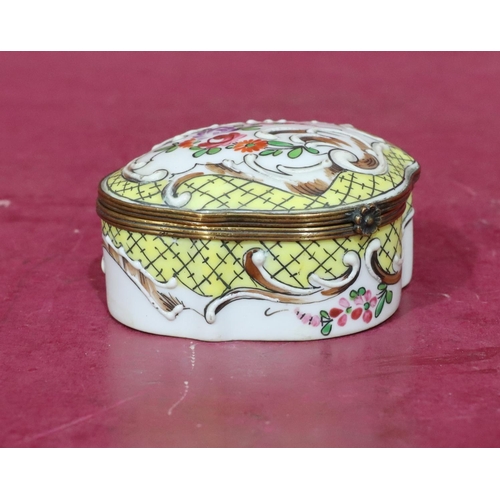 119 - A Continental scallop shaped china snuff box with hinged lid and allover raised and painted floral a... 