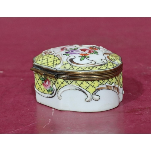 119 - A Continental scallop shaped china snuff box with hinged lid and allover raised and painted floral a... 