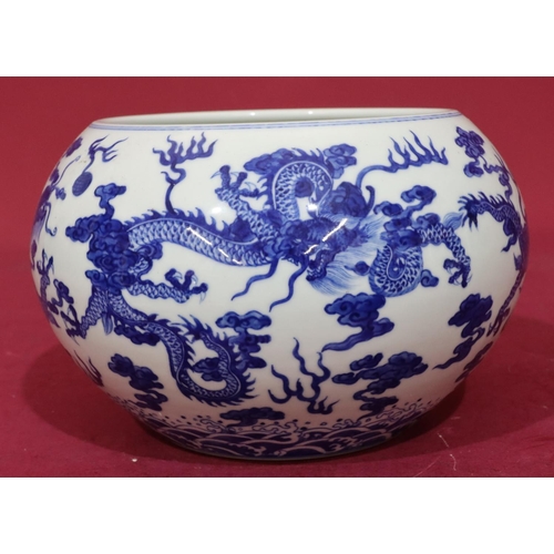 122 - An Oriental round bulbous shaped jardinière on blue and white ground with dragon decoration, 21c, di... 