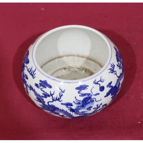 122 - An Oriental round bulbous shaped jardinière on blue and white ground with dragon decoration, 21c, di... 