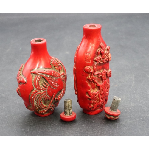 124 - 2 Oriental red snuff bottles with raised dragon and figure decoration (2)