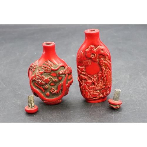 124 - 2 Oriental red snuff bottles with raised dragon and figure decoration (2)