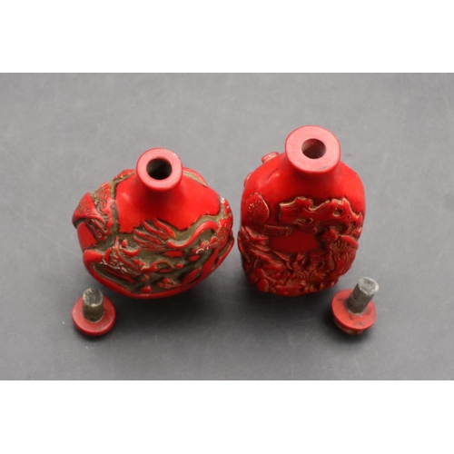 124 - 2 Oriental red snuff bottles with raised dragon and figure decoration (2)