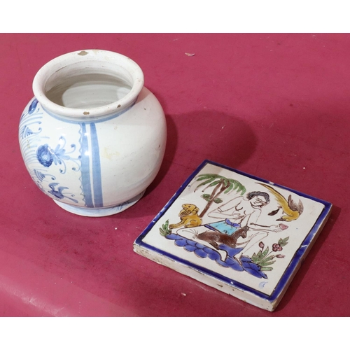 130 - An 18th Century Continental square tile with multicoloured seated figure, bird and animal motifs, 16... 