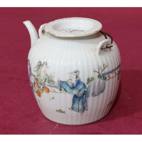 132 - An Oriental round bulbous reeded teapot on white ground with multicoloured Oriental figure and fence... 