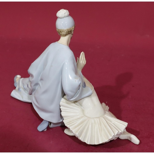 139 - A Lladro group of a seated Pierrot and Ballerina, 37cm wide, 23cm high