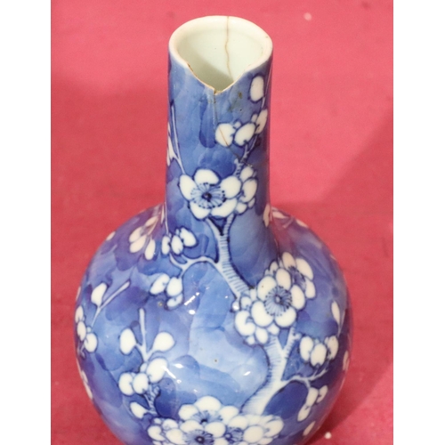 154 - An Oriental round bulbous thin neck vase on blue and white ground with branch and blossom decoration... 