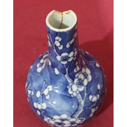 154 - An Oriental round bulbous thin neck vase on blue and white ground with branch and blossom decoration... 