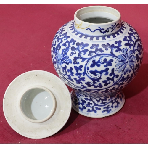 156 - A 19th Century Chinese round bulbous thin neck lidded pot on blue and white ground with allover flor... 