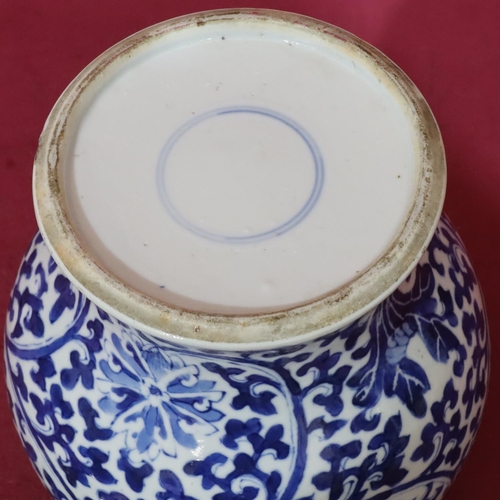 156 - A 19th Century Chinese round bulbous thin neck lidded pot on blue and white ground with allover flor... 