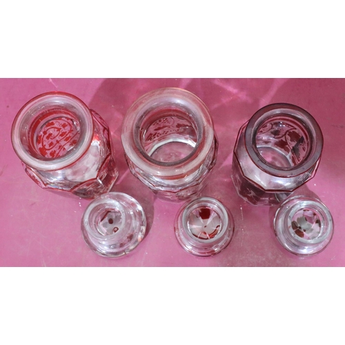 177 - 3 similar clear and red glass lidded storage jars with allover grape and vine decoration, largest, 1... 