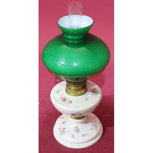 179 - A Meissen style oil lamp with green glass shade and chimney on white ground with multicoloured flora... 