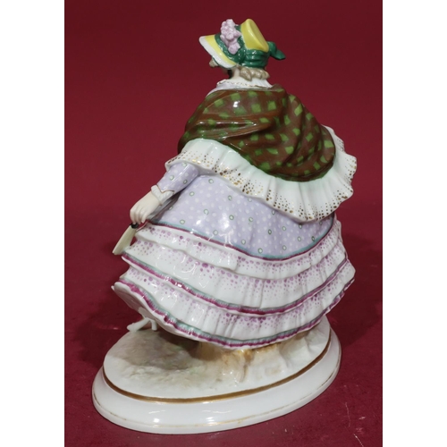 183 - A Continental china figure of a seated lady in lilac dress on oval base, 26cm high