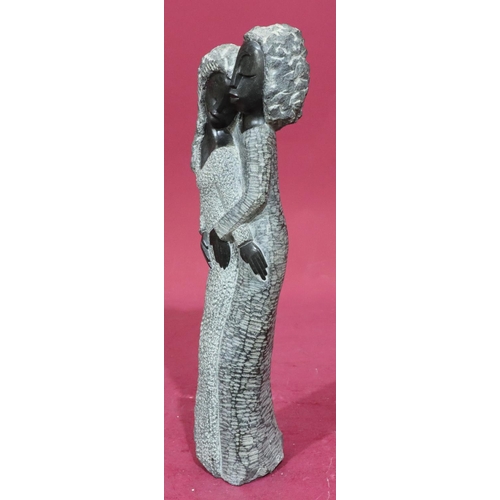 184 - A Shona style grey and black fleck stone group of 2 standing females, 42cm high