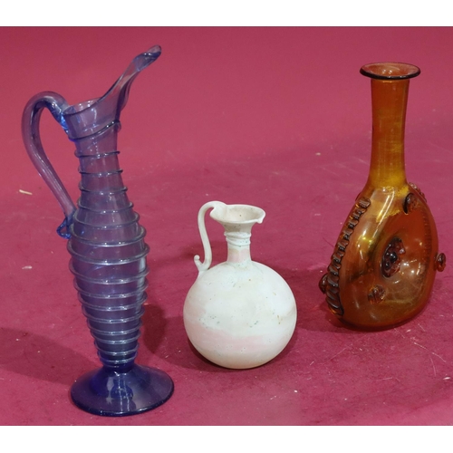 209 - An early glass bulbous shaped jug with scroll handle, 12.5cm high, a blue glass jug with raised ring... 