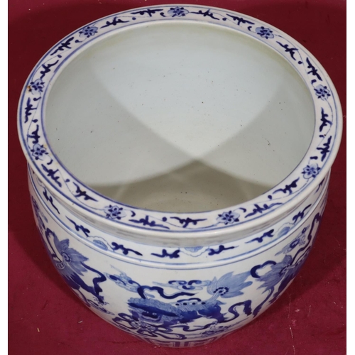 211 - A Chinese blue and white round bulbous shaped jardinière with allover dog of Pho, cloud and scroll d... 