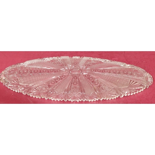 213 - A heavy cut glass oval shallow dish with tooth cut ring, 54.5cm wide