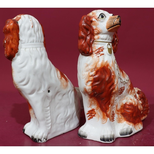 215 - A pair of 19th Century Staffordshire figures of seated spaniels on white and red ground with gilt ch... 