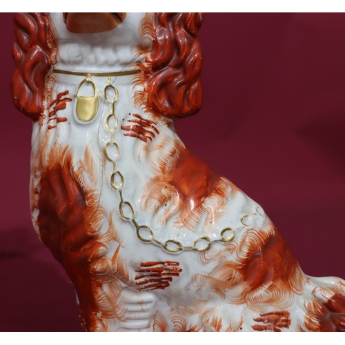 215 - A pair of 19th Century Staffordshire figures of seated spaniels on white and red ground with gilt ch... 