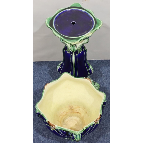 217 - A glazed earthenware square scallop shaped jardinière with matching stand on blue and green ground a... 