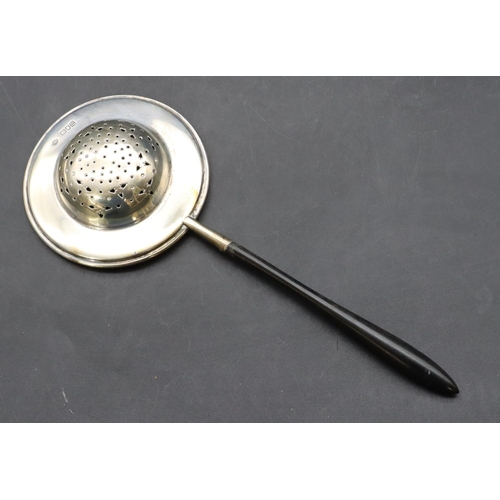 292 - A London silver tea strainer with turned ebony handle, 22cm long