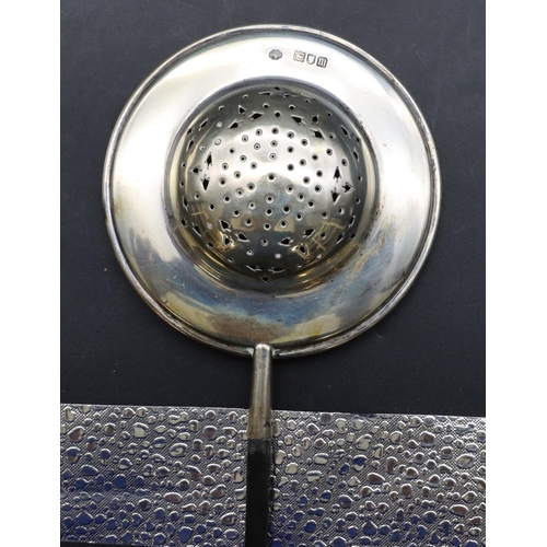 292 - A London silver tea strainer with turned ebony handle, 22cm long