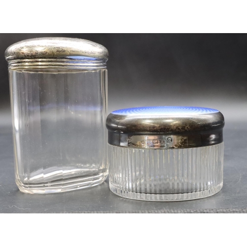 293 - A cut glass round dressing table bottle with Birmingham silver lid with blue enamel top, 8cm diamete... 