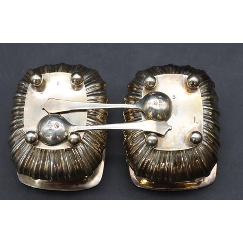 297 - A pair of Chester silver rectangular bulbous shaped salts with part embossed reeded decoration on ba... 