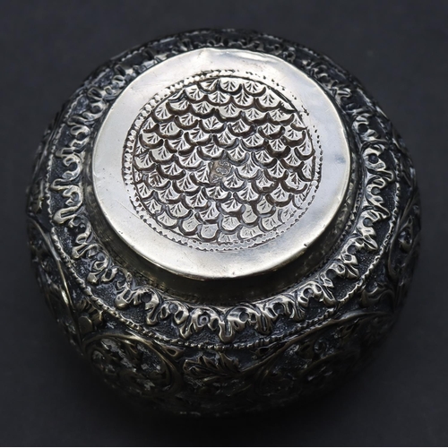 299 - An Eastern silver coloured metal small round bulbous shaped bowl with embossed leaf and scroll decor... 