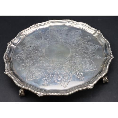 300 - A Victorian silver round scallop shaped card tray with raised ball rim and engraved centre on 4 claw... 