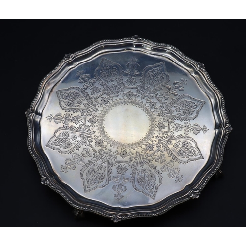 300 - A Victorian silver round scallop shaped card tray with raised ball rim and engraved centre on 4 claw... 