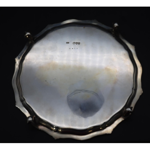 300 - A Victorian silver round scallop shaped card tray with raised ball rim and engraved centre on 4 claw... 