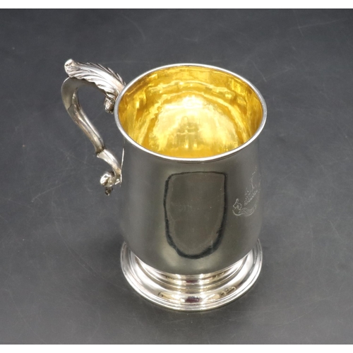 301 - An early George III silver round bulbous shaped tankard with scroll handle on sweeping foot, engrave... 