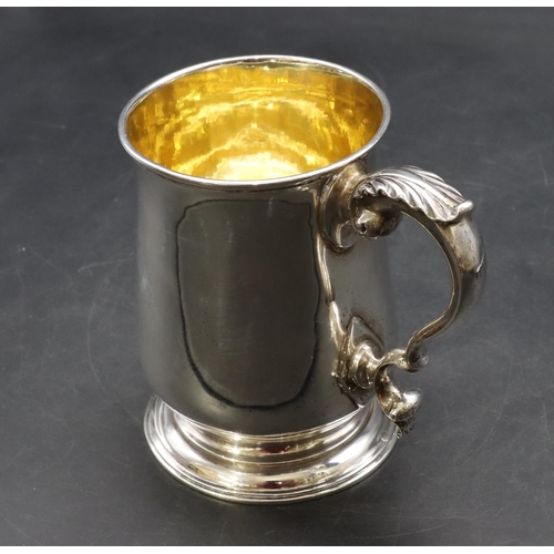 301 - An early George III silver round bulbous shaped tankard with scroll handle on sweeping foot, engrave... 