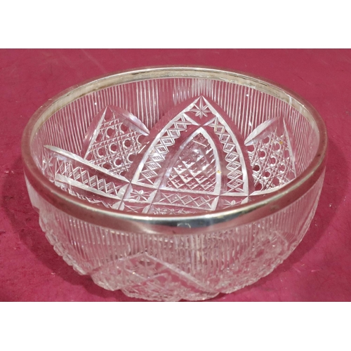 306 - A cut glass round fruit bowl with Birmingham silver rim, 18cm diameter