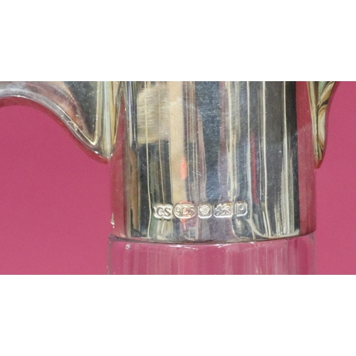 308 - A heavy cut glass claret jug with 925 plain silver neck, hinged lid and scroll handle, 30cm high