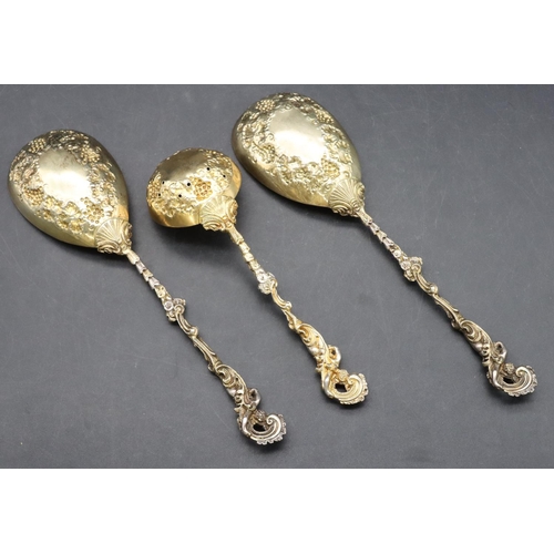 310 - A 3-piece late Victorian silver and silver gilt pair of serving spoons and a matching sugar sifter w... 