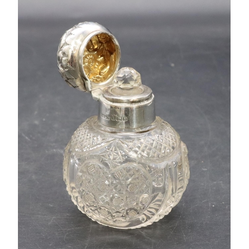 321 - A cut glass round bulbous shaped dressing table bottle with Birmingham silver neck, hinged lid with ... 