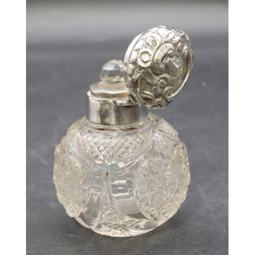 321 - A cut glass round bulbous shaped dressing table bottle with Birmingham silver neck, hinged lid with ... 