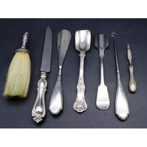 326 - A silver handled crumb brush with embossed decoration, a silver handled knife, a silver marrow scoop... 