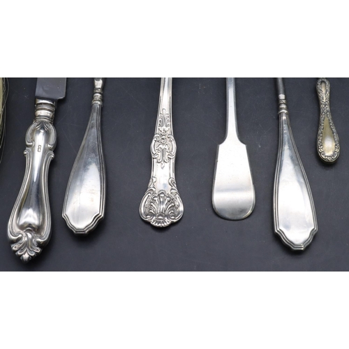 326 - A silver handled crumb brush with embossed decoration, a silver handled knife, a silver marrow scoop... 