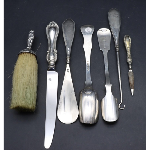 326 - A silver handled crumb brush with embossed decoration, a silver handled knife, a silver marrow scoop... 