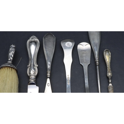 326 - A silver handled crumb brush with embossed decoration, a silver handled knife, a silver marrow scoop... 