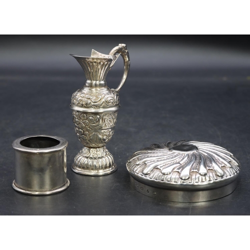 341 - A silver coloured metal small round bulbous shaped ewer with embossed floral and scroll decoration, ... 