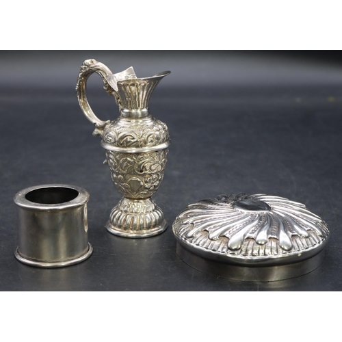 341 - A silver coloured metal small round bulbous shaped ewer with embossed floral and scroll decoration, ... 